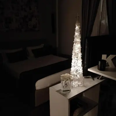 a room with a christmas tree on a table at K Rooms in Rome