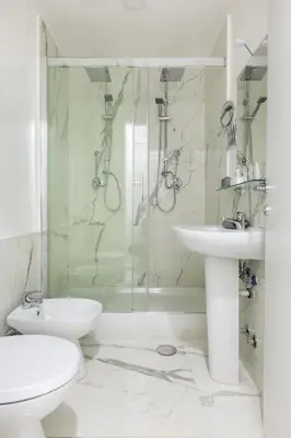 a bathroom with a shower and a toilet and a sink at Little Aurelius in Rome