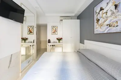 a bedroom with a bed and a flat screen tv at Little Aurelius in Rome