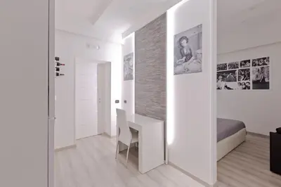 a white room with a desk and a bed at New Rome house 2 in Rome