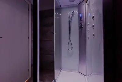 a bathroom with a shower with a glass door at New Rome house 2 in Rome