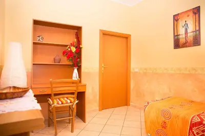 a bedroom with a desk and a bed and a chair at La Dolce Vita Colosseum in Rome