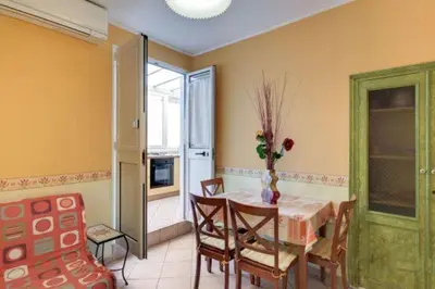 a dining room with a table and chairs in a room at La Dolce Vita Colosseum in Rome