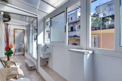 a bathroom with a toilet and a sink and windows at La Dolce Vita Colosseum in Rome