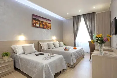 a hotel room with two beds in a room at AdoraSuite 2 in Rome