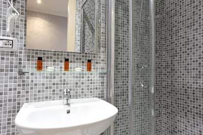 a bathroom with a sink and a shower at AdoraSuite 2 in Rome