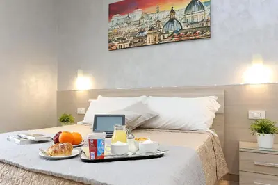 a breakfast tray on a bed with food on it at AdoraSuite 2 in Rome