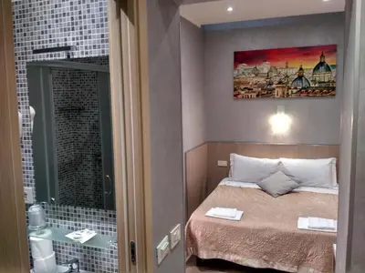 a small room with a bed and a bathroom at AdoraSuite 2 in Rome