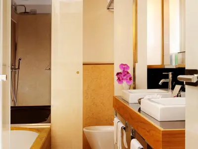 a bathroom with two sinks and a tub at Mario De' Fiori 37 in Rome