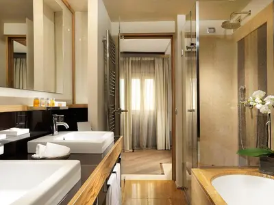 a bathroom with two sinks and a shower at Mario De' Fiori 37 in Rome