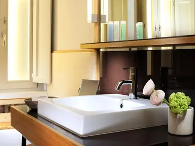 a bathroom with a white sink and a mirror at Mario De' Fiori 37 in Rome