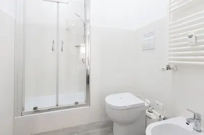 a bathroom with a shower and a toilet and a sink at 247 Luxury Rooms Trastevere in Rome