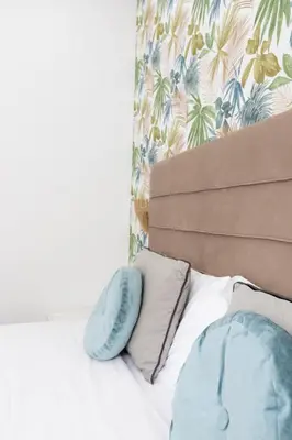 a bed with a headboard and two pillows at 247 Luxury Rooms Trastevere in Rome