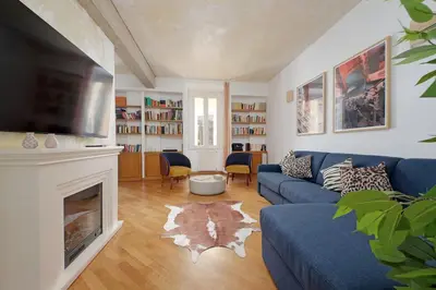 a living room with a blue couch and a fireplace at Casa Navona - My Extra Home in Rome