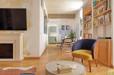 a living room with a fireplace and a tv at Casa Navona - My Extra Home in Rome