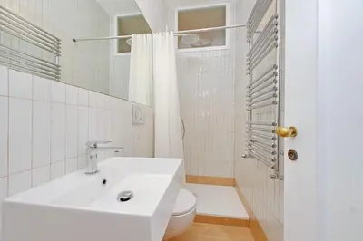 a white bathroom with a sink and a toilet at Casa Navona - My Extra Home in Rome