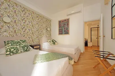 a living room with a couch and a chair at Casa Navona - My Extra Home in Rome