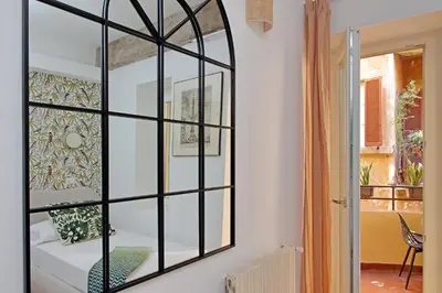 a mirror on a wall in a room with a bed at Casa Navona - My Extra Home in Rome