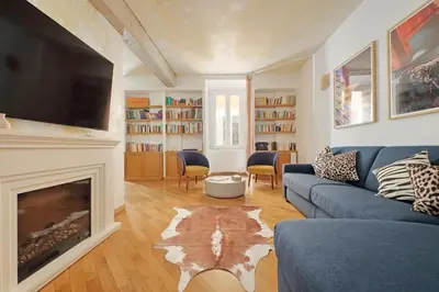 a living room with a blue couch and a fireplace at Casa Navona - My Extra Home in Rome