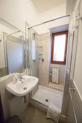 a white bathroom with a sink and a shower at Da Paolo al Vaticano in Rome