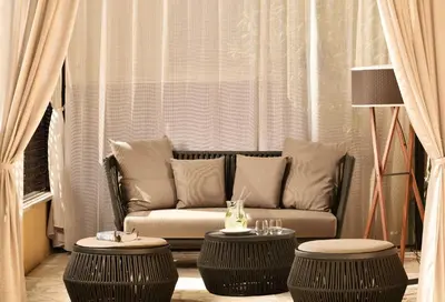 a living room with a couch and two tables at Margutta 19 - Small Luxury Hotels of the World in Rome