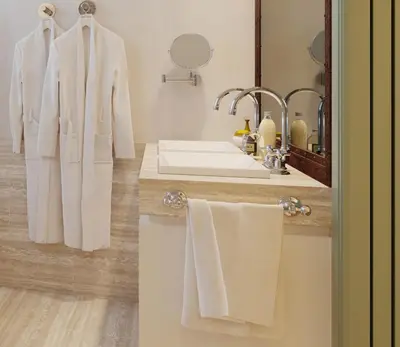 a bathroom with white towels and a sink at Margutta 19 - Small Luxury Hotels of the World in Rome
