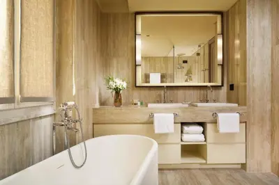 a bathroom with a tub and a sink and a mirror at Margutta 19 - Small Luxury Hotels of the World in Rome