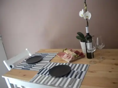 a table with a plate of food and a bottle of wine at Roman Holidays in Rome