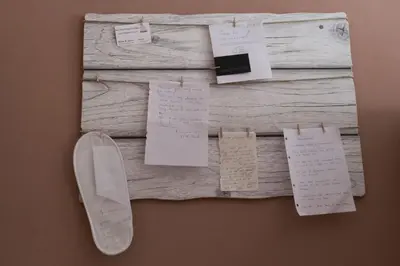 a piece of wood with notes on a wall at Roman Holidays in Rome