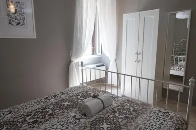 a bedroom with a bed with a pillow on it at Roman Holidays in Rome