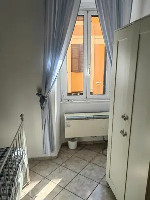 a small bathroom with a window and a crib at Roman Holidays in Rome