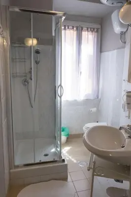 a bathroom with a shower and a sink and a toilet at Roman Holidays in Rome