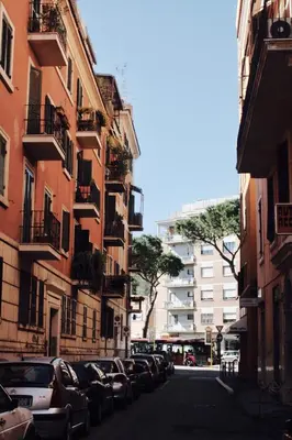 a city street with parked cars and buildings at Roman Holidays in Rome