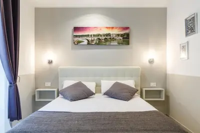 a bedroom with a white bed with two pillows at Sallustio Fine Rooms Guest House in Rome