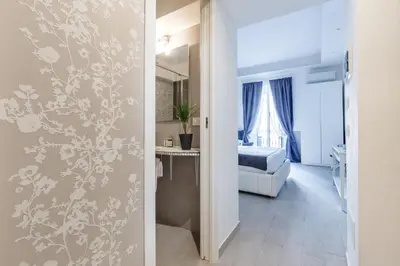 a hallway leading to a room with a bedroom at Sallustio Fine Rooms Guest House in Rome