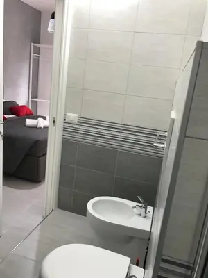 a bathroom with a toilet and a sink at Dunant House in Rome