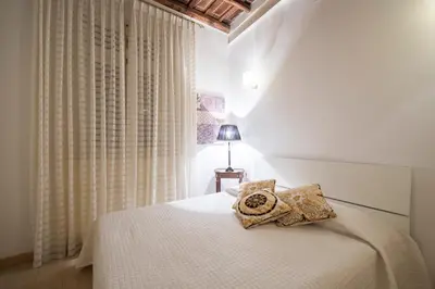 a living room with a couch and a glass table at Portico D'ottavia in Rome