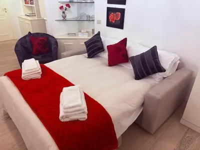a living room with a couch and a glass table at Portico D'ottavia in Rome