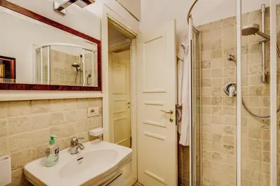 a small bedroom with a bed and a closet at Portico D'ottavia in Rome