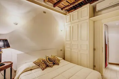 a bedroom with a large bed and a window at Portico D'ottavia in Rome