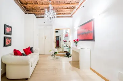 a living room with a white couch and a glass table at Portico D'ottavia in Rome