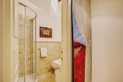 a bathroom with a shower and a toilet and a sink at Portico D'ottavia in Rome