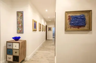 a hallway with paintings on the walls at Rifugio degli Artisti Top B&B in Rome