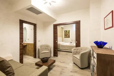 a living room with a bed and a couch and chairs at Rifugio degli Artisti Top B&B in Rome