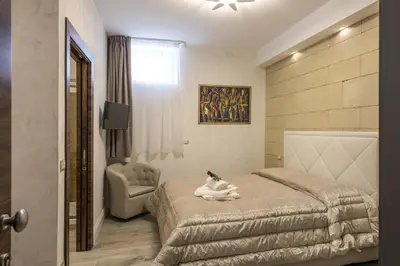 a hotel room with a bed and a chair at Rifugio degli Artisti Top B&B in Rome