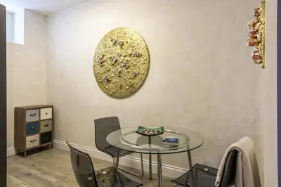 a dining room with a glass table and chairs at Rifugio degli Artisti Top B&B in Rome