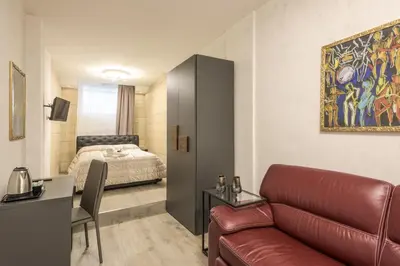 a living room with a couch and a bed at Rifugio degli Artisti Top B&B in Rome