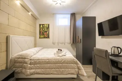 a bedroom with a bed with a cat laying on it at Rifugio degli Artisti Top B&B in Rome