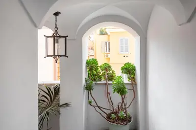 a hallway with potted plants and a chandelier at i Fiori de' Mario Suites in Rome