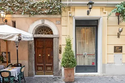 a door to a building with a table and a plant at i Fiori de' Mario Suites in Rome